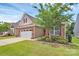 Charming home featuring brick and siding exterior, a two-car garage, and a well-maintained, landscaped front yard at 12014 Belmont Mansion Dr, Charlotte, NC 28273