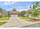 Exterior showcasing a well-manicured lawn, long driveway, and charming architecture with a mix of siding and brick elements at 12014 Belmont Mansion Dr, Charlotte, NC 28273