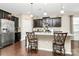 Bright kitchen featuring granite countertops, stainless steel appliances, and dark wood cabinets at 12014 Belmont Mansion Dr, Charlotte, NC 28273