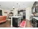 Open kitchen with granite countertops, stainless steel appliances, and dark wood cabinetry at 12014 Belmont Mansion Dr, Charlotte, NC 28273