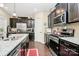 Kitchen featuring stainless steel appliances, dark cabinetry, and a granite countertop island, combining style and functionality at 12014 Belmont Mansion Dr, Charlotte, NC 28273