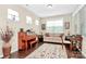Comfortable living room with natural light, a piano, and a cozy sitting area at 12014 Belmont Mansion Dr, Charlotte, NC 28273
