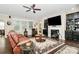 Spacious living room with a ceiling fan, fireplace, and built-in shelving at 12014 Belmont Mansion Dr, Charlotte, NC 28273