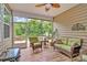 Comfortable covered outdoor patio with peaceful backyard views and ample seating at 12014 Belmont Mansion Dr, Charlotte, NC 28273