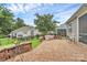 Spacious outdoor patio surrounded by a low stone wall, offering views of the expansive backyard and mature trees at 12014 Belmont Mansion Dr, Charlotte, NC 28273