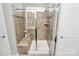 Modern tiled shower with glass door and built-in bench, providing a spa-like experience at 12014 Belmont Mansion Dr, Charlotte, NC 28273