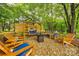 Relaxing outdoor lounge area with swing and chairs set in a peaceful, landscaped setting at 1206 Craig Ave, Lancaster, SC 29720