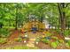 Relaxing outdoor lounge area with swing and chairs set in a peaceful, landscaped setting at 1206 Craig Ave, Lancaster, SC 29720