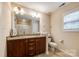Bathroom with double vanity, granite countertop, framed mirror, and neutral paint at 1206 Craig Ave, Lancaster, SC 29720