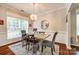 Bright dining room features decorative wood trim, a modern chandelier, and large windows at 1206 Craig Ave, Lancaster, SC 29720