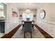 Bright dining room features decorative wood trim, a modern chandelier, and large windows at 1206 Craig Ave, Lancaster, SC 29720