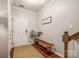 Bright foyer with hardwood floors, a wooden bench, a decorative sign, and views of the staircase at 1206 Craig Ave, Lancaster, SC 29720