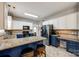 Bright kitchen featuring granite countertops, white upper cabinets, blue base cabinets, and stainless appliances at 1206 Craig Ave, Lancaster, SC 29720
