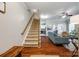 Open-concept living room featuring hardwood floors, a staircase, and seamless flow into the dining area and kitchen at 1206 Craig Ave, Lancaster, SC 29720