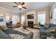 Comfortable living room with a fireplace, large windows and hardwood floors with views to the dining room at 1206 Craig Ave, Lancaster, SC 29720