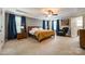 Spacious main bedroom with wood paneling, ceiling fan, and large windows at 1206 Craig Ave, Lancaster, SC 29720