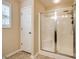 Bathroom showcasing a glass-enclosed shower stall and white paneled door at 1206 Craig Ave, Lancaster, SC 29720