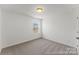 Cozy bedroom with soft carpeting, a window overlooking the neighborhood, and neutral walls for easy personalization at 1216 Links Crossing Dr # 159, Monroe, NC 28112