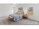 Bright bedroom features soft carpet, a large window, and a comfortable king bed with stylish decor at 1216 Links Crossing Dr # 159, Monroe, NC 28112