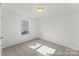 Bright bedroom with neutral carpet, white walls, and a window at 1216 Links Crossing Dr # 159, Monroe, NC 28112