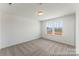 Bright bedroom features neutral carpet, white walls, and double windows at 1216 Links Crossing Dr # 159, Monroe, NC 28112