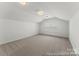 Versatile bonus room featuring plush carpeting, neutral walls, and natural light, ideal for various activities at 1216 Links Crossing Dr # 159, Monroe, NC 28112
