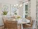 Dining area with a round table, wicker chairs, stylish decor, and natural light at 1216 Links Crossing Dr # 159, Monroe, NC 28112