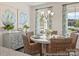 Dining area with a round table, wicker chairs, stylish decor, and natural light at 1216 Links Crossing Dr # 159, Monroe, NC 28112
