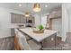 Modern kitchen featuring stainless steel appliances, a large island, and an open layout at 1216 Links Crossing Dr # 159, Monroe, NC 28112