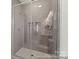 Tiled shower boasts sleek glass doors, enhancing the bathroom's modern design and functionality at 1216 Links Crossing Dr # 159, Monroe, NC 28112