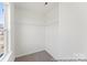 A walk-in closet with white walls, shelves, and neutral carpet at 1216 Links Crossing Dr # 159, Monroe, NC 28112