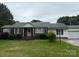 Charming ranch-style home featuring a brick facade, white siding, green lawn, and mature trees at 1292 Longview Rd, Rock Hill, SC 29732