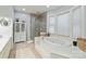 Bright bathroom features a soaking tub, glass shower, tiled floor and ample natural light at 1520 Cureton Dr, Rock Hill, SC 29732