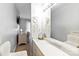 Bright, clean bathroom featuring vanity with ample storage, large mirror, and a dressing table at 1520 Cureton Dr, Rock Hill, SC 29732
