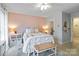 Charming bedroom with a pink accent wall, white furniture, and a decorative bench at 1520 Cureton Dr, Rock Hill, SC 29732
