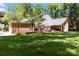 Expansive backyard view highlighting the home's architecture, patio, and meticulously maintained lawn with mature trees at 1520 Cureton Dr, Rock Hill, SC 29732