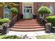 Brick staircase leads to the front door and sidelights with potted flowers at 1520 Cureton Dr, Rock Hill, SC 29732