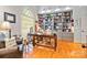 Inviting home office featuring a large window, built-in bookcase, hardwood floors and comfortable seating at 1520 Cureton Dr, Rock Hill, SC 29732