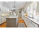 Open kitchen with an island, stone countertops, white cabinets, and modern appliances at 1520 Cureton Dr, Rock Hill, SC 29732