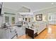 Bright living room featuring hardwood floors, neutral tones, and ample seating, open to the dining area at 1520 Cureton Dr, Rock Hill, SC 29732