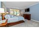 Relaxing main bedroom featuring a large bed, light blue walls, and backyard access at 1520 Cureton Dr, Rock Hill, SC 29732