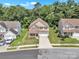 Aerial view of a home with a two-car garage, a partially brick facade, and a manicured lawn at 15203 Oldcorn Ln, Charlotte, NC 28262