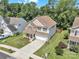 A slightly-angled aerial view of the home, its landscaping, and neighborhood at 15203 Oldcorn Ln, Charlotte, NC 28262