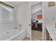 Bathroom features a bathtub, window, and access to the main bedroom at 15203 Oldcorn Ln, Charlotte, NC 28262