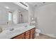 Bathroom features double sinks, tile flooring, and a shower with white tiling at 15203 Oldcorn Ln, Charlotte, NC 28262