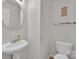 Powder room with modern fixtures, pedestal sink, and minimalist design at 15203 Oldcorn Ln, Charlotte, NC 28262
