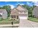 Charming two-story home featuring a stone facade, a covered front porch, and an attached two-car garage at 15203 Oldcorn Ln, Charlotte, NC 28262