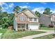 Charming two-story home featuring a stone facade, a covered front porch, and an attached two-car garage at 15203 Oldcorn Ln, Charlotte, NC 28262