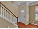 Inviting foyer features hardwood floors, a staircase, and a bright front door at 15203 Oldcorn Ln, Charlotte, NC 28262