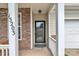 Charming front entrance features stone accents and a covered porch, creating a welcoming appeal at 15203 Oldcorn Ln, Charlotte, NC 28262